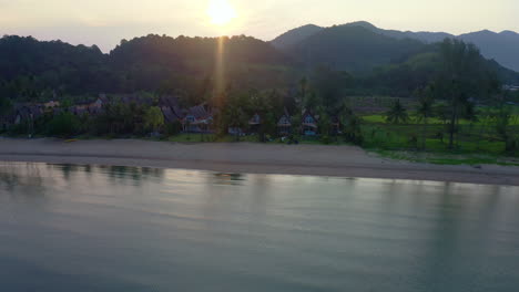 Bungalow-cottages-on-calm-beach-in-Koh-Chang-at-dawning-sunrise