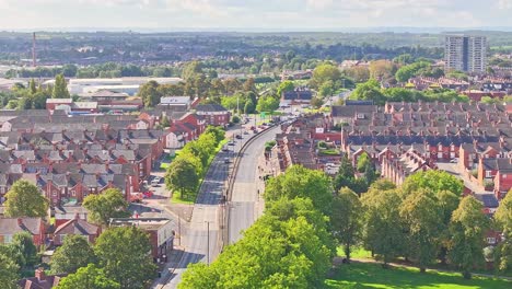 Drone-rises-above-bend-in-the-road-between-suburban-neighborhood-in-Doncaster-England