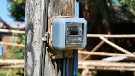 Close-Up-Footage-of-Electricty-Meter-in-Rural-Villlge,-Thailand