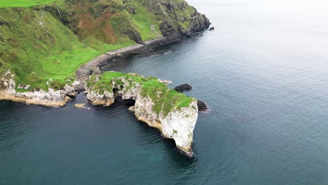 Aerial-parallax-view-of-stunning-cliffs-on-a-gorgeous-coastline-from-Kibane-Castle-in-Northern-ireland-along-the-giant-Causeway-coastal-road-during-an-exciting-journey-through-the-country