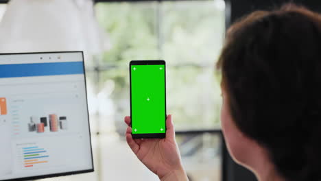 Worker-examines-phone-with-greenscreen