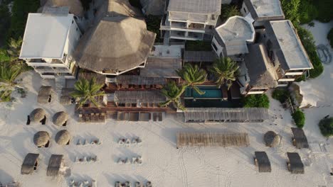 Drone-view-of-a-sandy-beach-at-sunset-at-Amansala-hotel-resort-in-the-village-of-Tulum