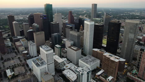 Aerial-overview-of-the-streets-and-buildings-of-Houston,-sunset-in-TX,-USA