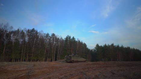 Leopard-tank-in-standbye-mode-on-a-sandy-soil-in-a-forest