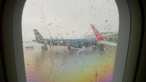 Looking-through-the-aircraft-window-to-see-torrential-rain-waiting-on-me