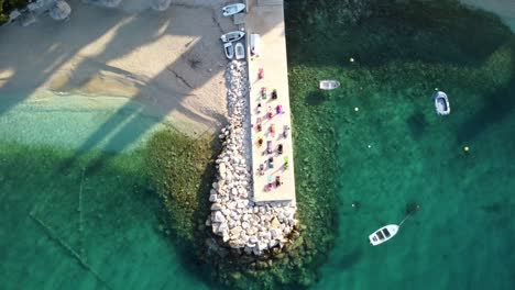 Active-People-Doing-Daily-Exercise-On-Pier-By-The-Adriatic-Sea-In-Brist,-Dalmatia,-Croatia