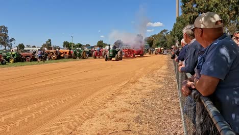 Yarrawonga,-Victoria,-Australia---7-October-2023:-Old-green-tractor-blowing-smoke-and-working-hard-to-pull-the-sled-in-a-tractor-pull-at-the-Yarrawonga-Show-in-Victoria-Australia