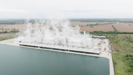 Natural-Gas-Power-Plant-Near-a-Cooling-Pond-in-the-Countryside,-Aerial-View