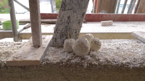 Detail-view-of-test-sample-balls-of-hempcrete-in-a-construction-site