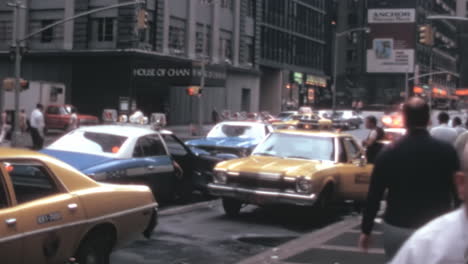 Police-Cars-and-Yellow-Taxies-Parked-on-New-York-7th-Avenue-in-the-1970s