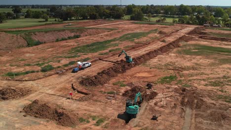 Yarrawonga,-Victoria,-Australia---20-October-2023:-Two-excavators-digging-trenches-on-the-new-stage-at-Silverwoods-Estate-in-Yarrawonga,-Victoria,-Australia