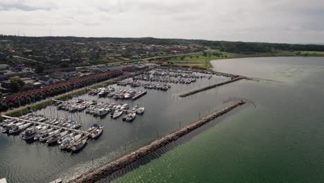 Aerial-View-Sailboats-Docked-in-Marina-Full-of-Sailboats,-Yachts-And-Boats