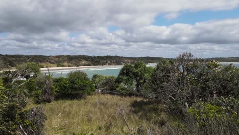 Revealing-cinematic-view-of-a-coastal-Australian-headland-walking-track-leading-to-a-hidden-ocean-bay