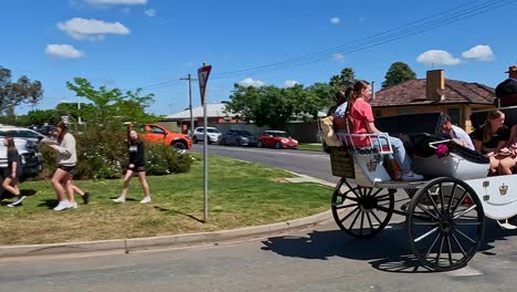 Yarrawonga,-Victoria,-Australia---7-October-2023:-Two-horses-drawing-a-carriage-with-passengers-outside-the-Yarrawonga-Show-in-Victoria-Australia