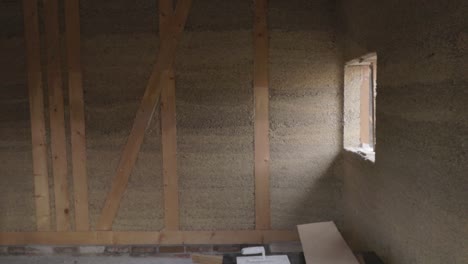 Inside-view-of-a-hempcrete-wall-in-wooden-frame-with-windows-unter-construction