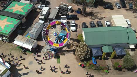 Yarrawonga,-Victoria,-Australia---7-October-2023:-Close-aerial-view-of-the-Tornado-amusement-ride-tilting-and-spinning-at-the-Yarrawonga-Show