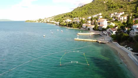 Antenne-In-Richtung-Pier-Am-Strand-Miosici-Im-Dorf-Brist,-Dalmatien,-Kroatien