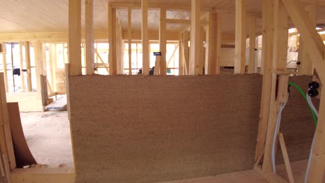 Panning-inside-a-half-finished-hempcrete-wall-and-zooming-into-electrical-installation-tubes-in-wooden-frame