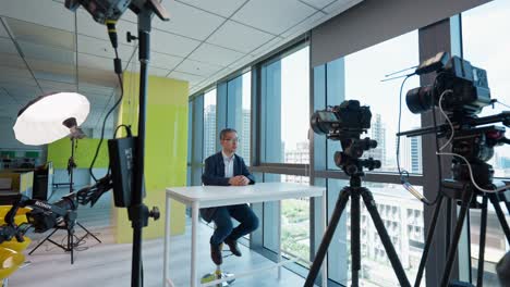 Behind-the-Scene-of-Man-Speaking-to-Two-Cameras-in-Office-Interior-Studio-setup
