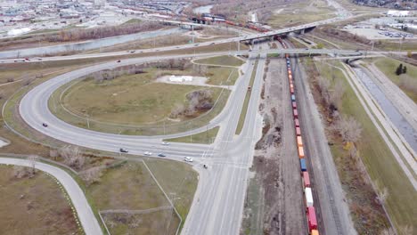 In-Calgary's-industrial-area,-a-long-train-waits-on-the-rails