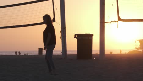 Huntington-Beach-at-sunset-and-family-playing-in-sand,-children-running-in-California,-USA