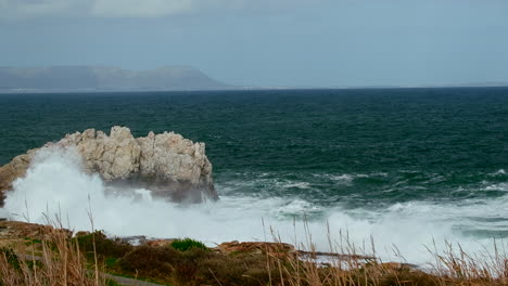 Turbulent-waves-crash-into-rocky-Hermanus-coastline