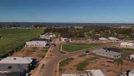 Yarrawonga,-Victoria,-Australia---21-September-2023:-Overhead-new-homes-at-Silverwoods-Estate-towards-new-park-and-Lake-Mulwala-in-the-background