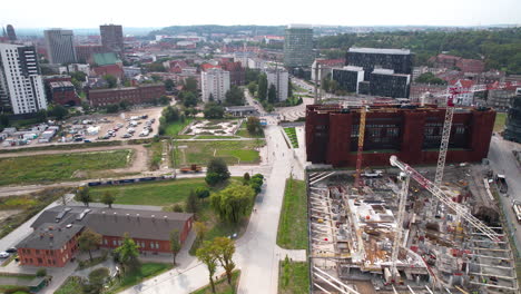 Aerial-View-Of-Construction-Site-With-Cranes-In-The-Vicinity-Of-European-Solidarity-Centre-Near-The-Monument-to-the-Fallen-Shipyard-Workers-of-1970-In-Gdansk