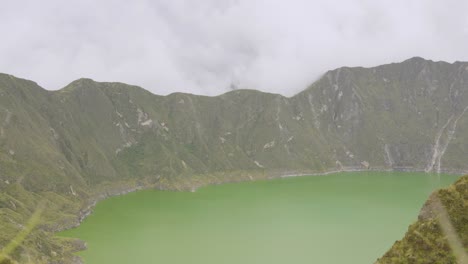 Quilotoa-Lagoon,-Timelapse-View-of-Volcanic-Crater-Lake-Surrounded-by-Mountains-and-Clouds