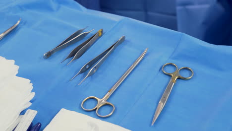 Surgical-instruments-on-table-in-operating-theatre-at-hospital,-close-up