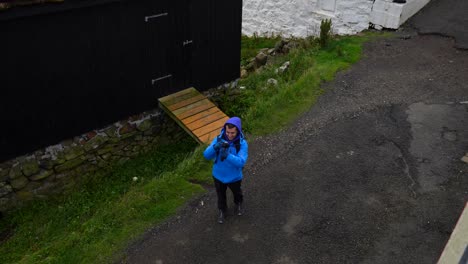 Man-captures-windy-Mykines-aware-he-is-filmed,-Faroe-Islands