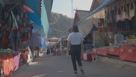 Low-angle-view-Woman-walking-along-Street-market-stalls-in-Chiang-Mai