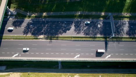 Aerial-View-Of-Cars-Driving-In-The-Highway-On-A-Sunny-Day