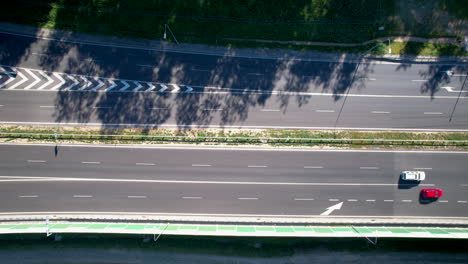 Overhead-View-Of-Vehicles-Driving-Through-The-Asphalt-Lanes-Of-Highway