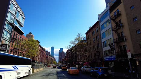 Pov-shot-on-american-road-with-taxis-in-New-York-City-during-sunny-day-with-blue-sky