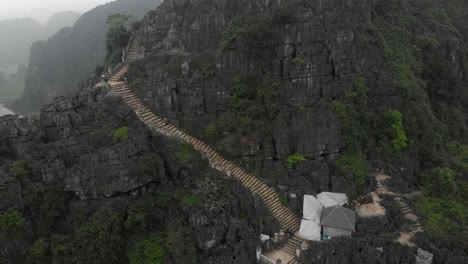 Tilt-up-shot-of-Mua-cave-viewpoint-at-Ninh-Binh-Vietnam,-aerial