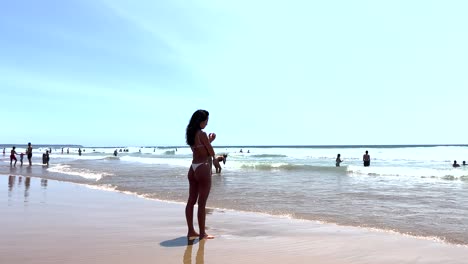 close-view-of-woman-gazes-thoughtfully-at-the-sea-with-her-feet-in-the-water