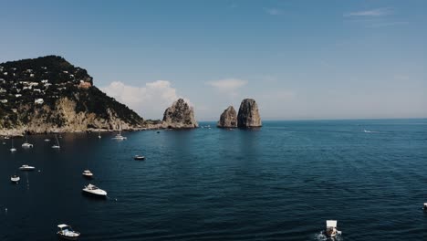 Aerial-of-Capri,-Italy's-beautiful-sea-water-filled-with-boats
