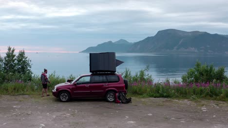 Traveler-With-Rooftop-Tent-Parked-Along-The-Lakeshore-In-Sifjord-Camping,-Norway