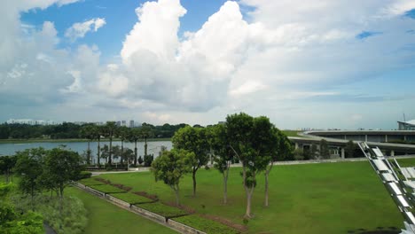 Aerial-over-park-area-of-Marina-Barrage,-an-impressive-engineering-marvel-and-a-vital-part-of-Singapore's-sustainable-development