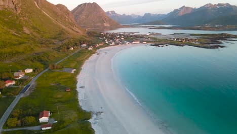Aerial-view-of-Ramberg-beach-bay-with-mountains-landscape-in-the-background