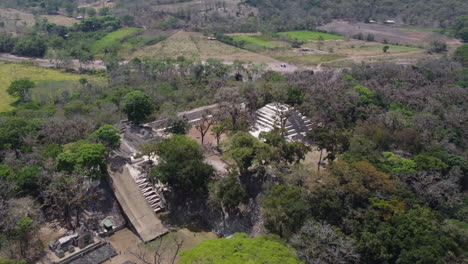 Flyover-partly-excavated-Mayan-temple,-pyramid-ruins,-Copan-Honduras