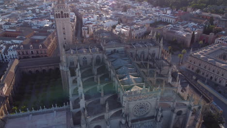 Aerial-Tilt-down-On-Gothic-Rooftop-Of-Seville-Cathedral-On-A-Sunny-Morning-In-Sevilla,-Spain