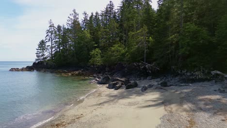 Moresby-Island-Along-a-Coastal-Beach-with-Forest-Trees,-Aerial-Dolly-Shot,-BC,-Canada