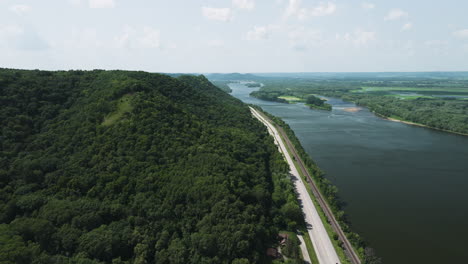 Aerial-View-Of-A-Dense-Forest-And-Coastal-Road-In-Great-River-Bluffs-State-Park-In-Minnesota,-United-States