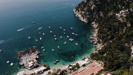 Wide-aerial-view-of-boats-lining-Italy's-coastal-water