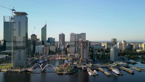Aerial-view-of-Elizabeth-Quay-in-Perth-City-with-skyline-and-parking-boats-at-pier-during-golden-sunset