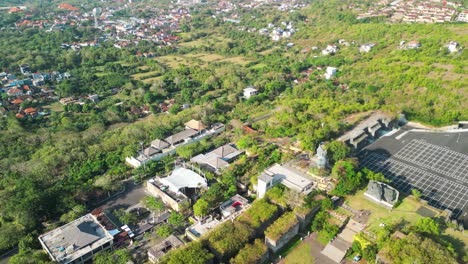 Aerial-during-sunshine-day-over-Garuda-Wisnu-Kencana,-an-renowned-cultural-park-located-in-Bali,-Indonesia