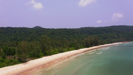 Tropical-jungle-coastline-with-sea-waves-washing-upon-Koh-Kood-beach