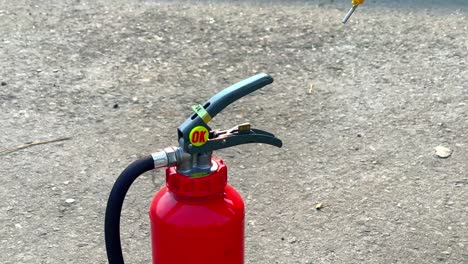 Unsealing-a-fire-extinguisher,-close-up-shot